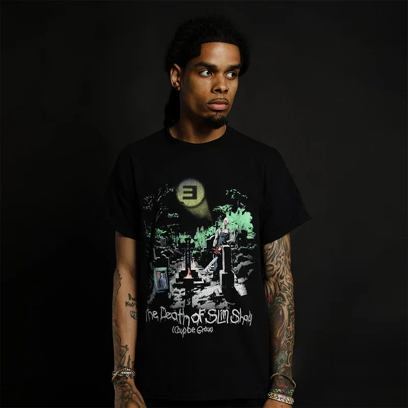Man wearing the black Eminem TDOSS Graveyard T-shirt with green moonlit cemetery art