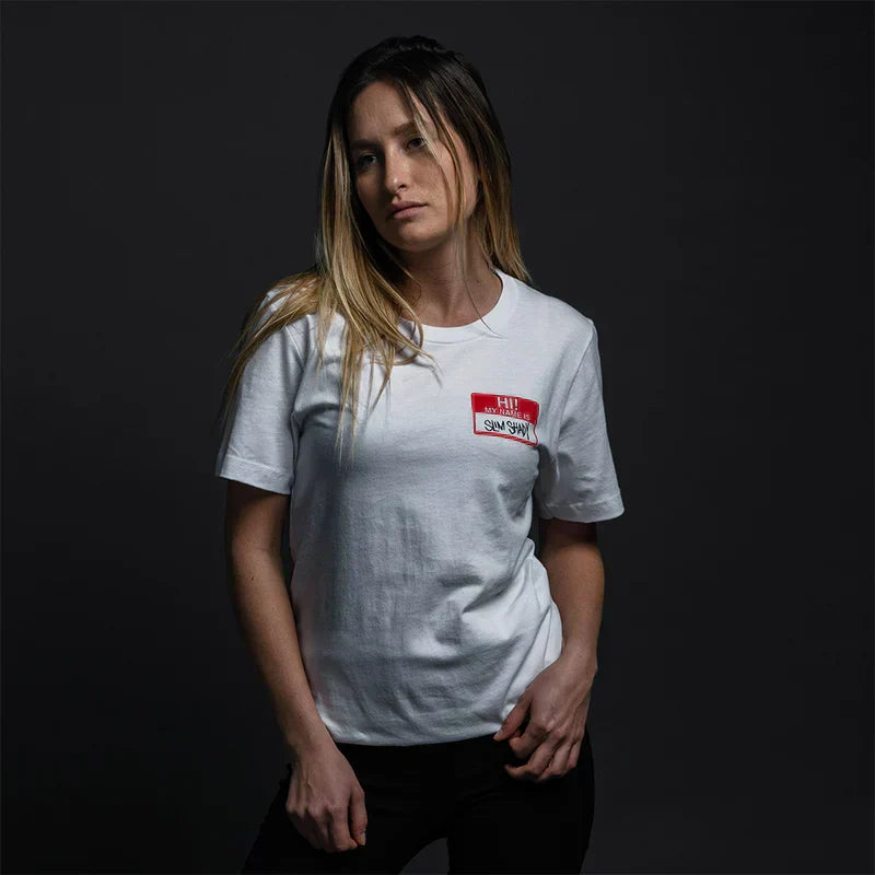 Woman wearing the white Eminem Hi My Name Is sticker logo T-shirt, red chest print