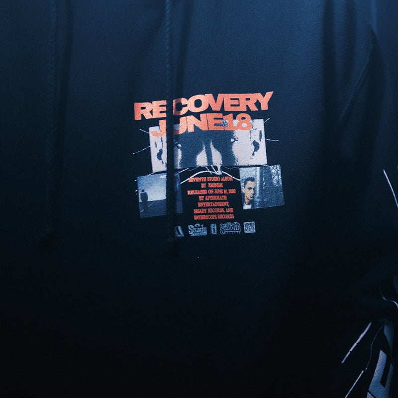 Close-up of the Recovery collage chest print on the black Eminem Anniversary hoodie