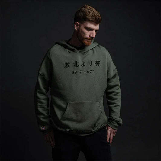Man wearing the olive green Eminem Kamikaze hoodie with Japanese kanji and Kamikaze chest print