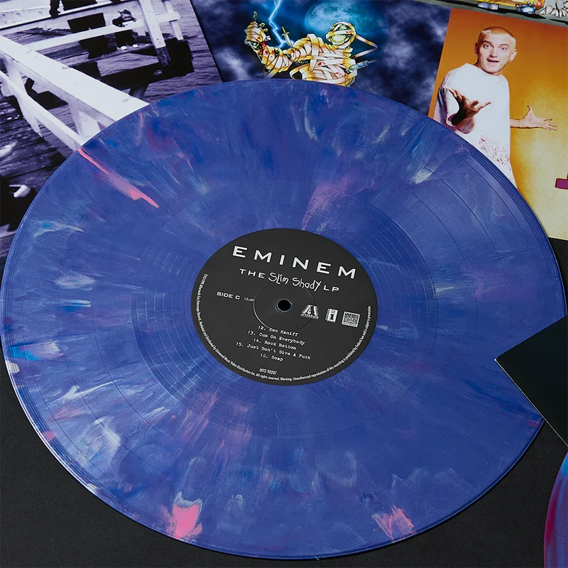 Eminem Shady LPs blue marbled vinyl record with album sleeves behind it