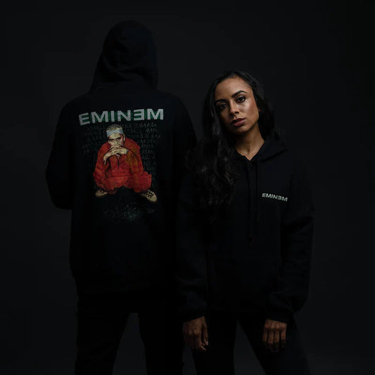 Two models in black Eminem Orange Jumpsuit hoodies with green logo and photo print