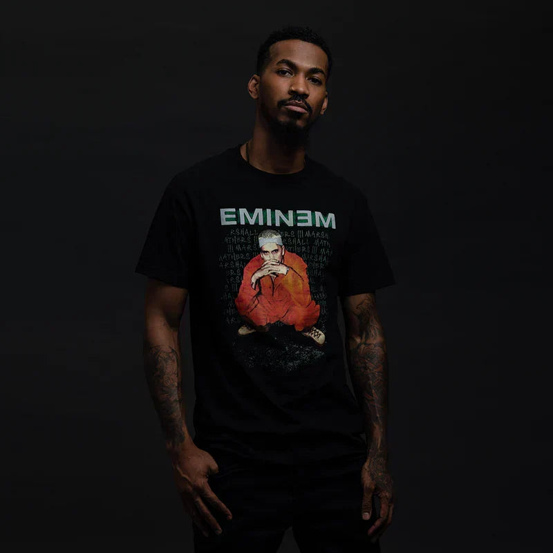 Man wearing the black Eminem Orange Jumpsuit photo T-shirt with green Eminem logo