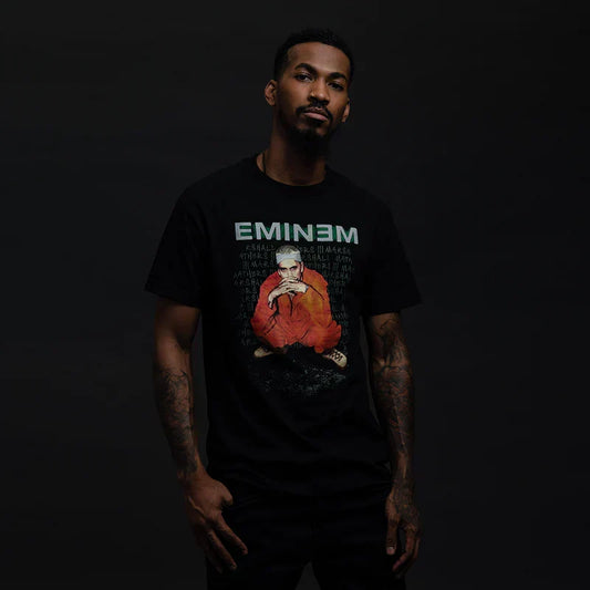 Man wearing the black Eminem Orange Jumpsuit photo T-shirt with green Eminem logo