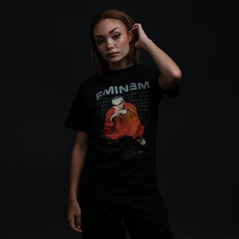 Woman wearing the black Eminem Orange Jumpsuit photo T-shirt, seated portrait print