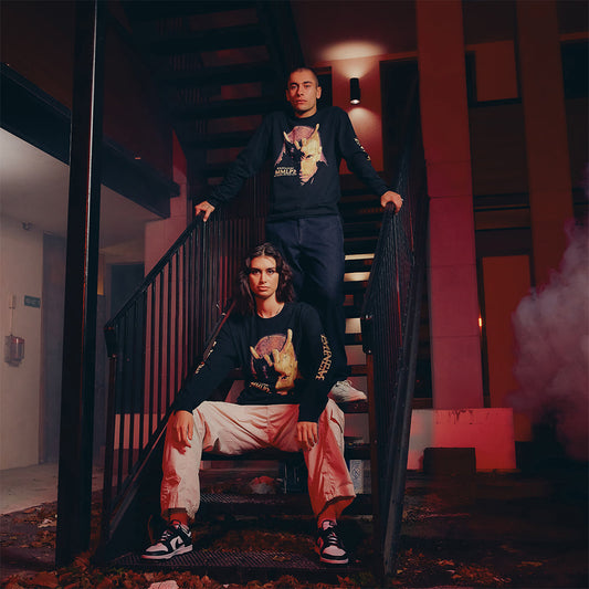 Two models in black Eminem MMLP2 Horns long sleeve shirts on a staircase