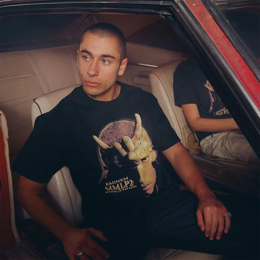 Man wearing the black Eminem MMLP2 Horns T-shirt with gold horned portrait print