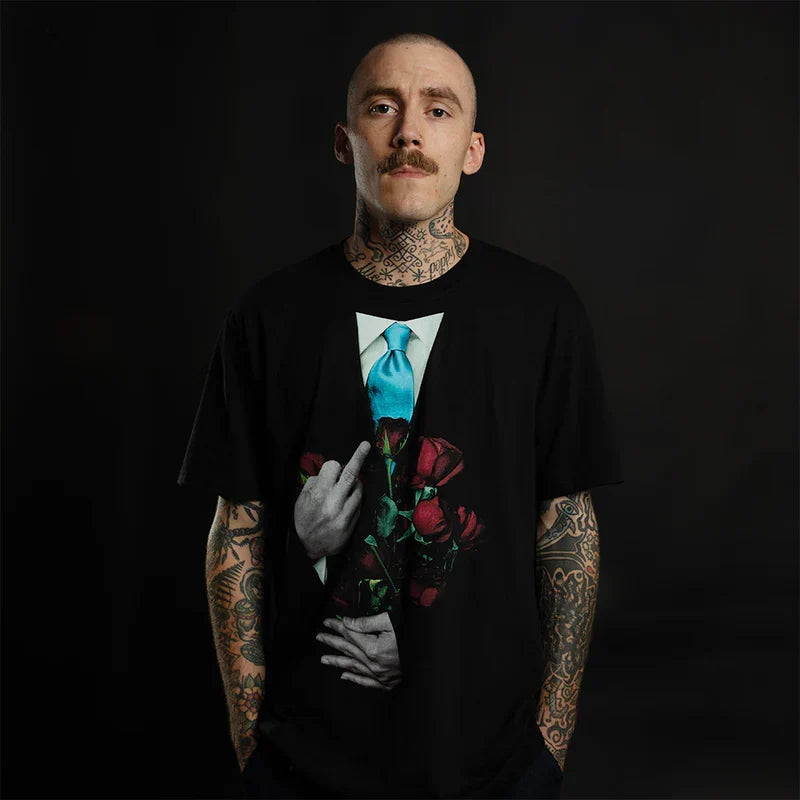Man wearing the black Eminem TDOSS Middle Finger Roses T-shirt with red rose graphic