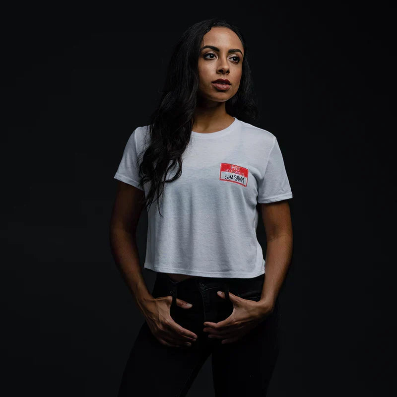 Woman wearing the white Eminem Hi! My Name Is cropped T-shirt with red name tag print