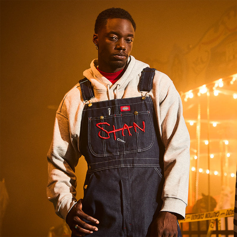 Man wearing the Eminem Stan denim overalls with red Stan chest embroidery