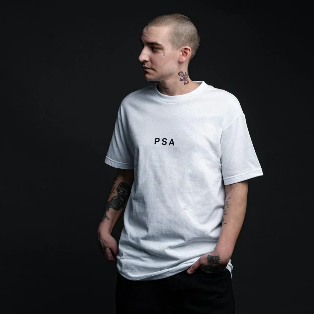 Man wearing the white Eminem PSA Don't Do Drugs T-shirt, minimal PSA chest print