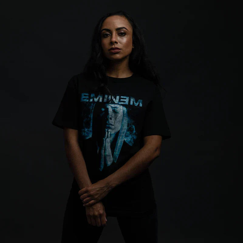 Woman wearing the black Eminem Praying graphic T-shirt with blue Eminem logo