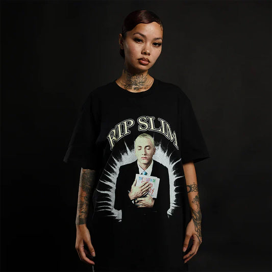 Woman wearing the black Eminem RIP Slim T-shirt with memorial portrait graphic