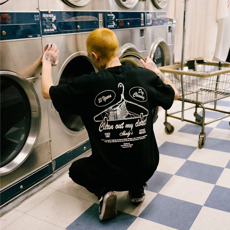 Back of the black Eminem Shady Cleaners T-shirt worn in a laundromat