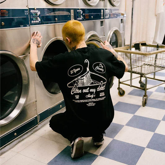 Back of the black Eminem Shady Cleaners T-shirt worn in a laundromat