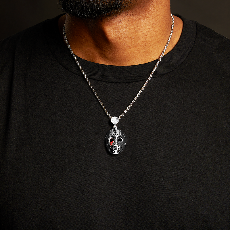 Man wearing the silver Eminem hockey mask pendant and chain over a black T-shirt