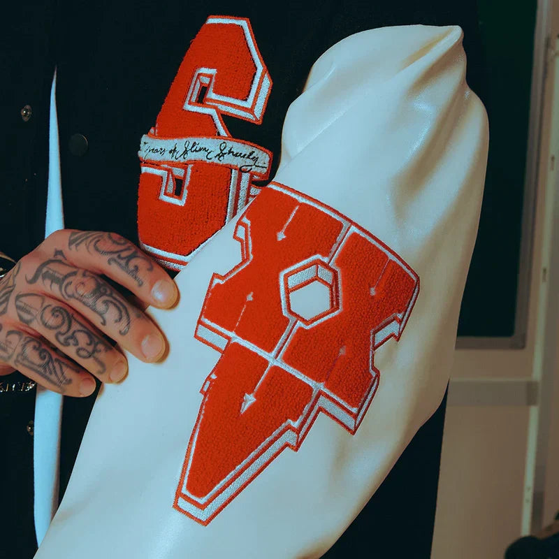 Sleeve patch detail on the Eminem SSLP25 varsity jacket with red lightning graphics