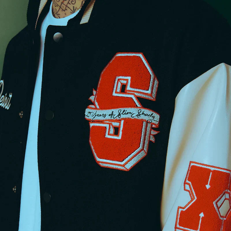 Red chenille S patch detail on the Eminem SSLP25 varsity jacket sleeve