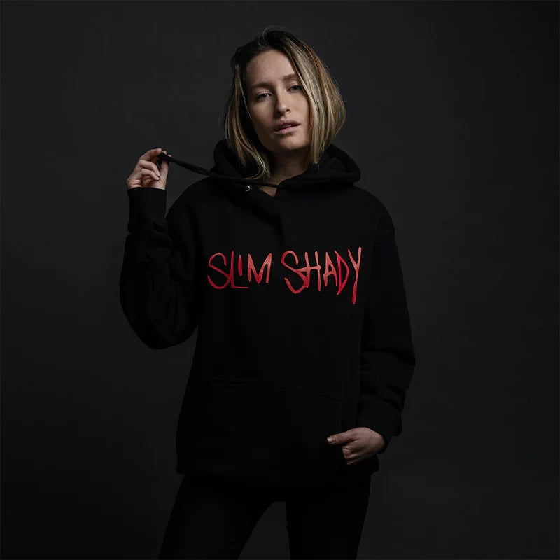 Woman wearing the black Eminem Slim Shady hoodie with red script lettering