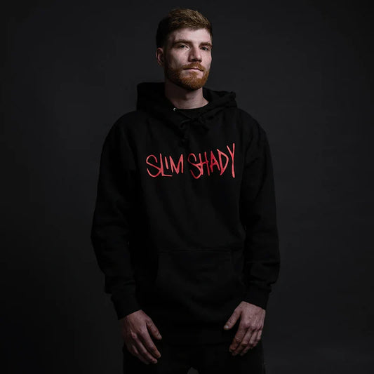 Man wearing the black Eminem Slim Shady hoodie with red graffiti chest print