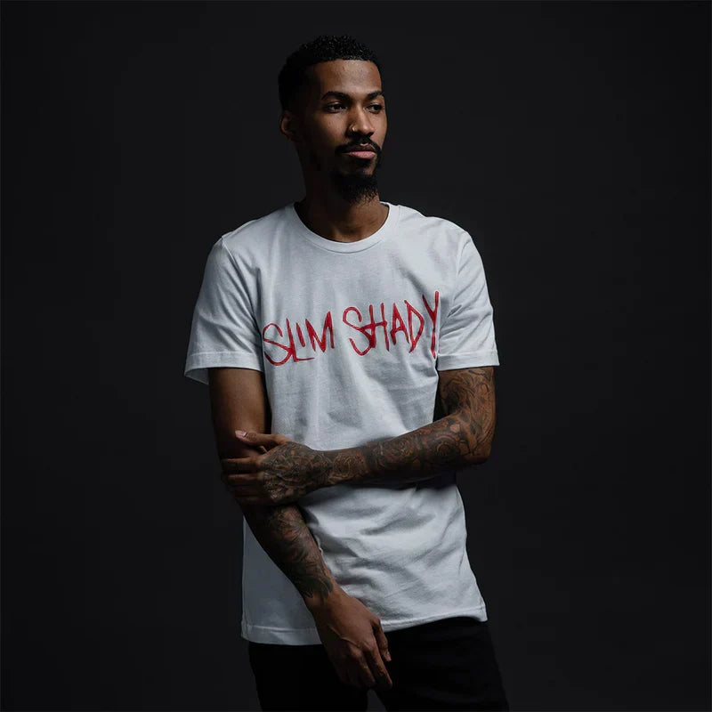 Man wearing the white Eminem Slim Shady Signature T-shirt with red graffiti chest print