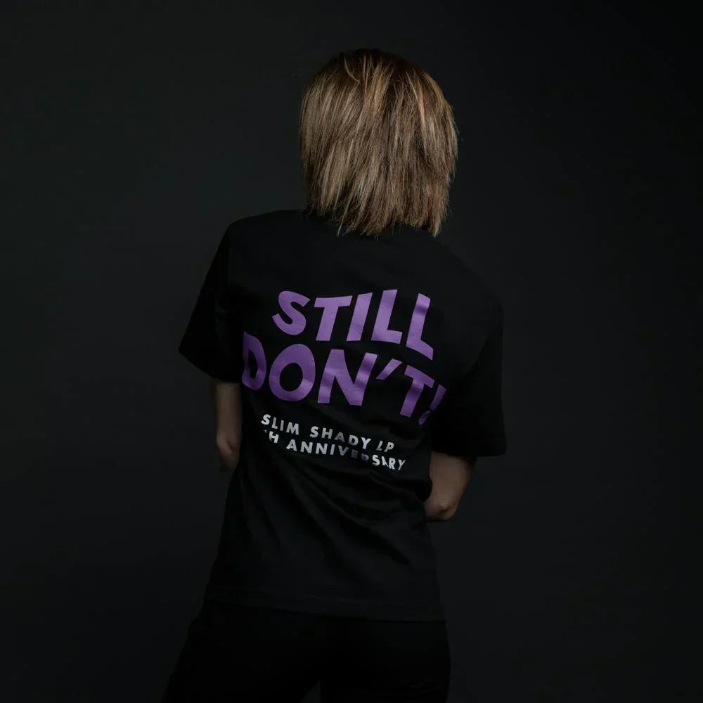 Back view of the black Eminem Still Don't T-shirt with purple stacked lettering