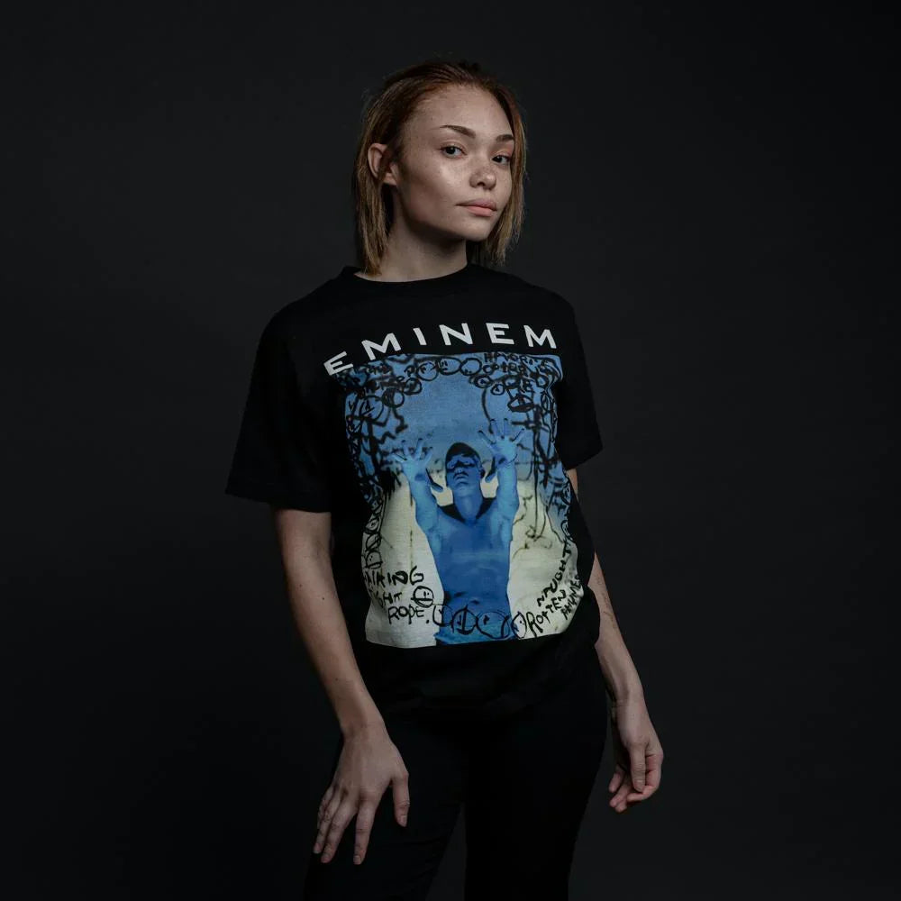Woman wearing the black Eminem Still Don't T-shirt with blue photo panel print