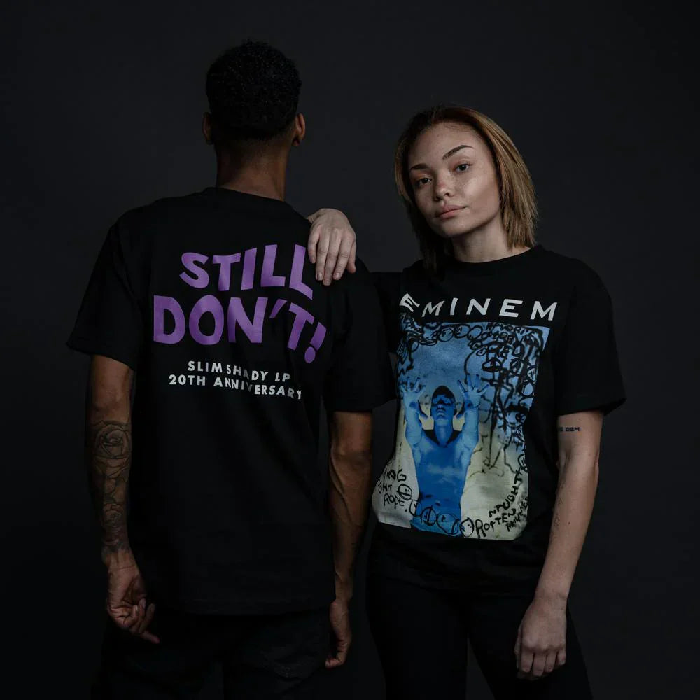 Two models in black Eminem Still Don't T-shirts with purple type and blue photo print