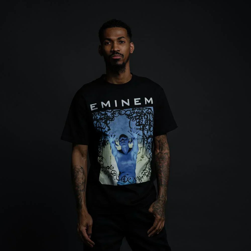 Man wearing the black Eminem Still Don't T-shirt with blue-toned photo graphic