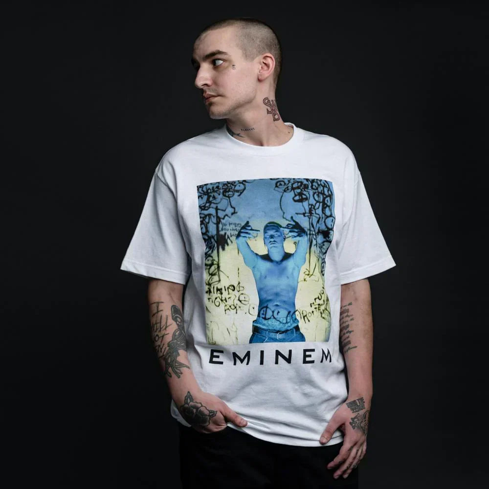 Man wearing the white Eminem Still Don't T-shirt with blue photo panel and Eminem logo