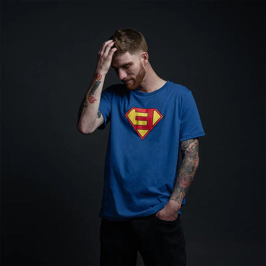Man wearing the blue Eminem Super-E logo T-shirt with comic shield chest graphic
