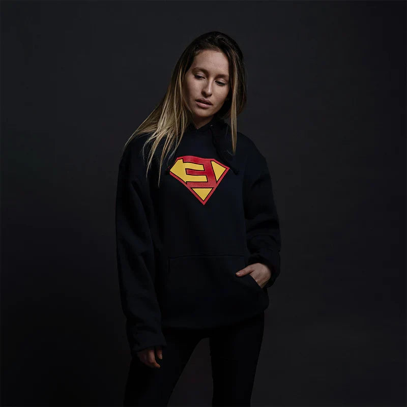 Woman wearing the black Eminem Super-E logo hoodie, comic-style shield graphic