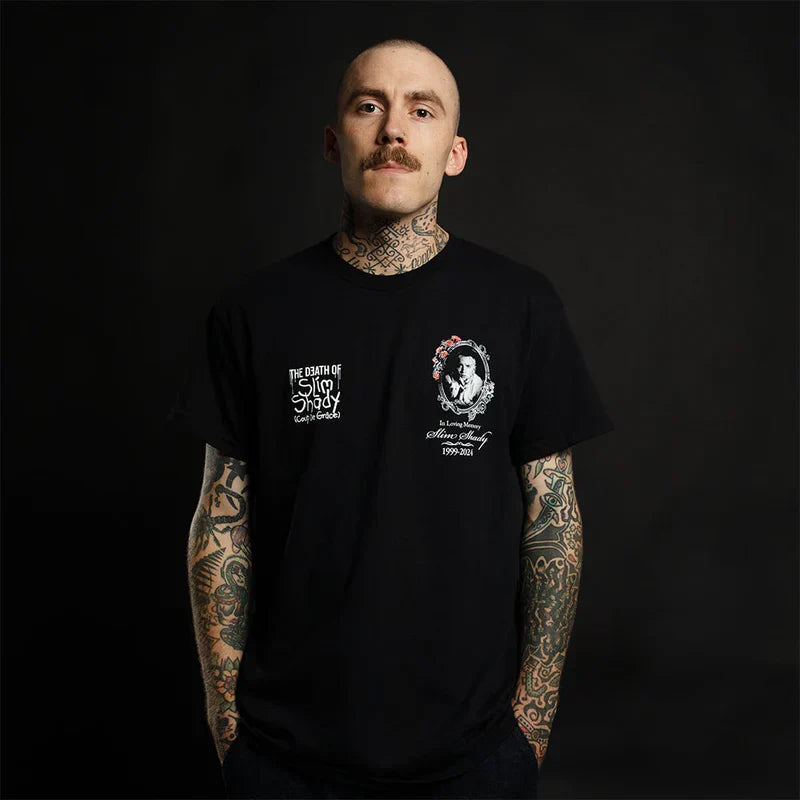 Man wearing the black Eminem TDOSS In Loving Memory T-shirt with small chest prints