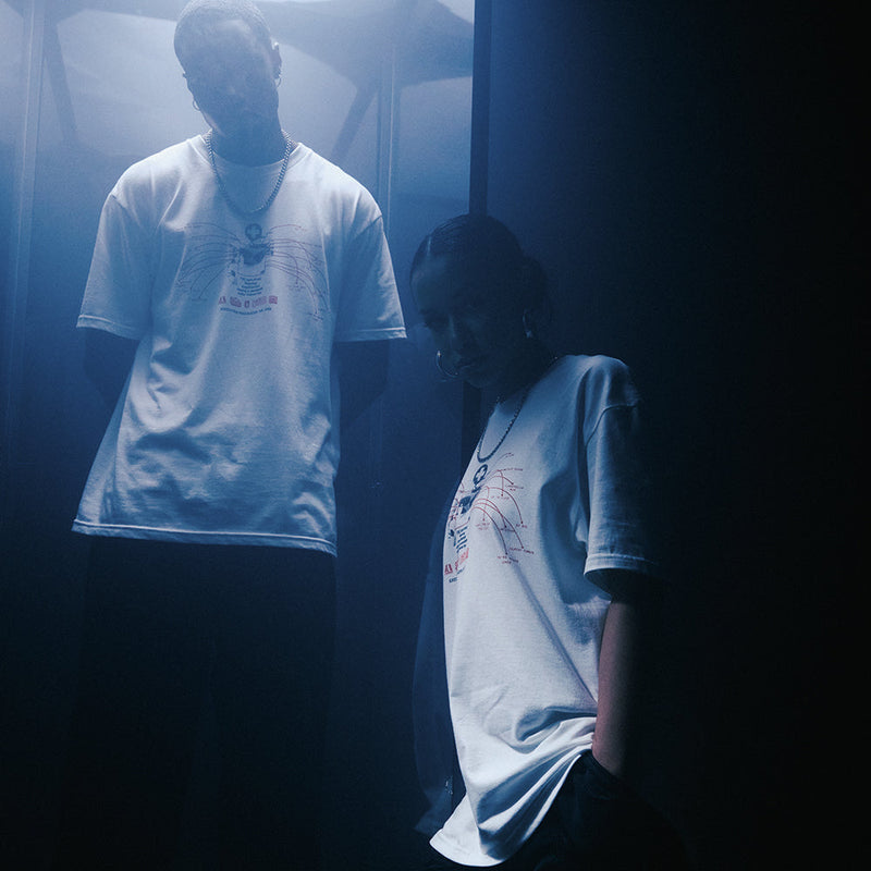 Models in white Eminem Recovery Anniversary T-shirts in a blue-lit corridor