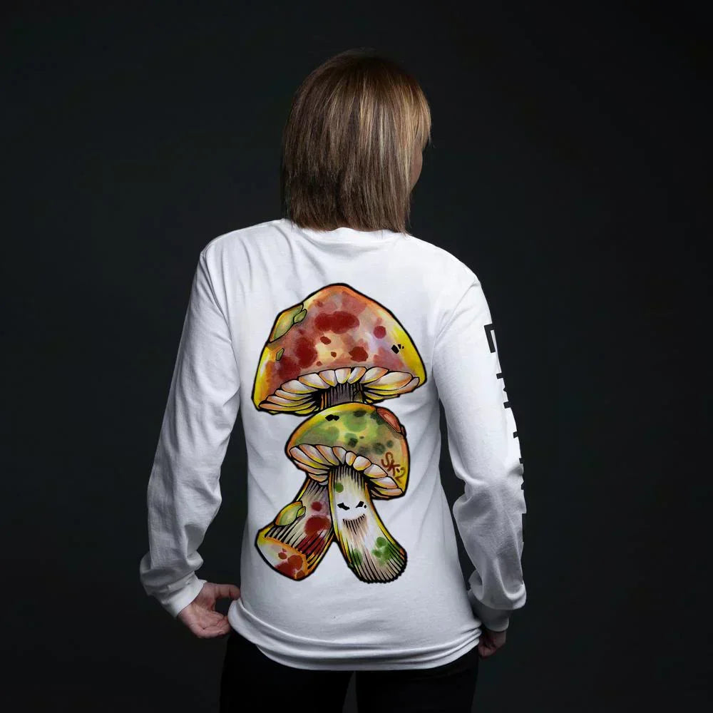 Woman showing the back of the white Eminem Brain Damage long sleeve shirt, mushroom graphic