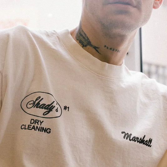 Close-up of the Shady's Dry Cleaning and Marshall chest prints on the cream Eminem T-shirt