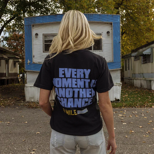 Back of black Eminem 8 Mile T-shirt reading Every Moment Is Another Chance in blue block type