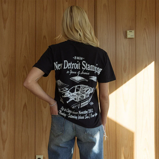 Woman wearing black Eminem 8 Mile New Detroit Stamping T-shirt, white back print with car line art