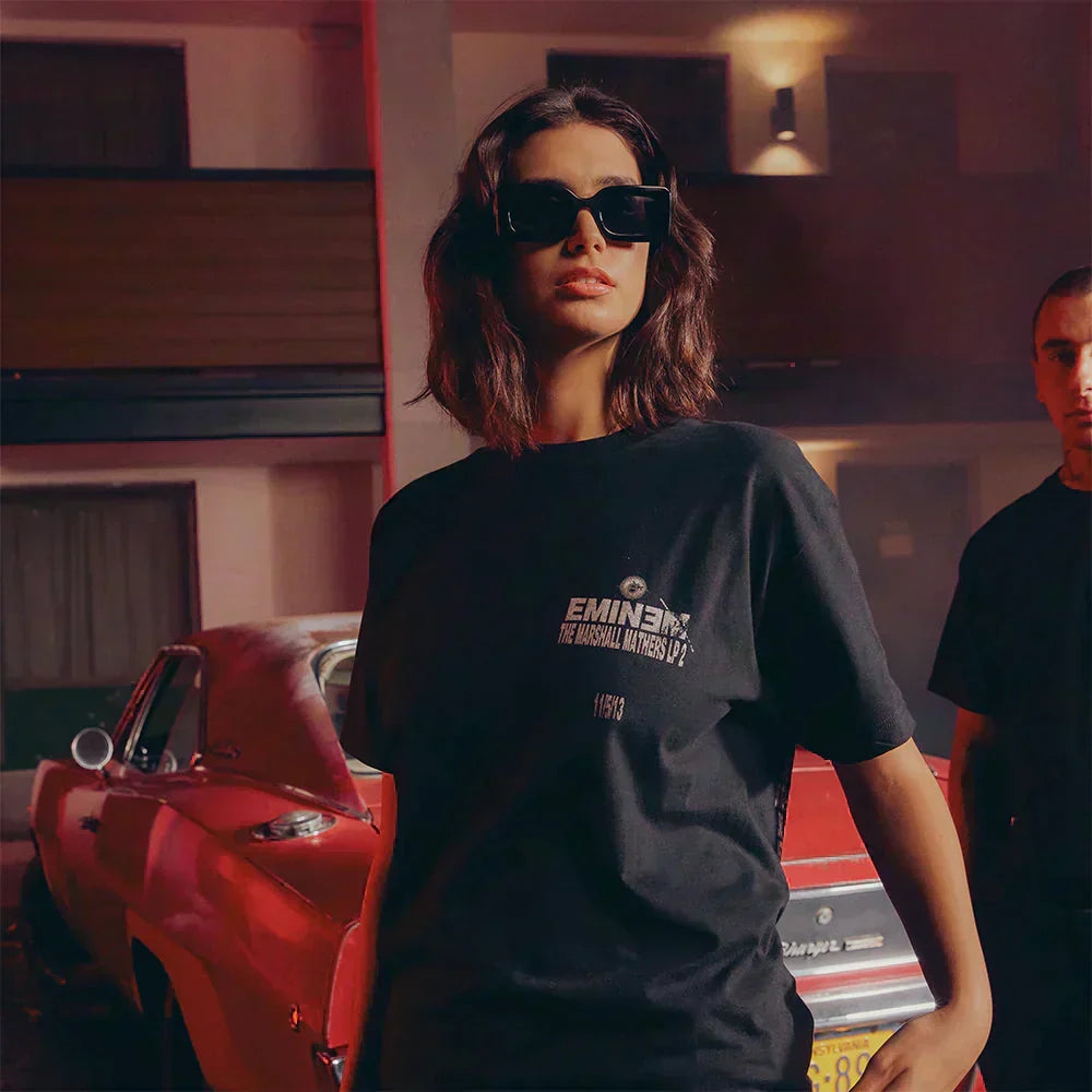 Woman wearing the black Eminem Berzerk lyric T-shirt with Marshall Mathers LP 2 chest print