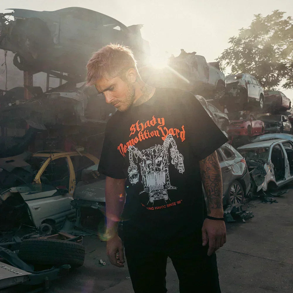 Man wearing the black Eminem Shady Demolition Logo T-shirt with red and white print