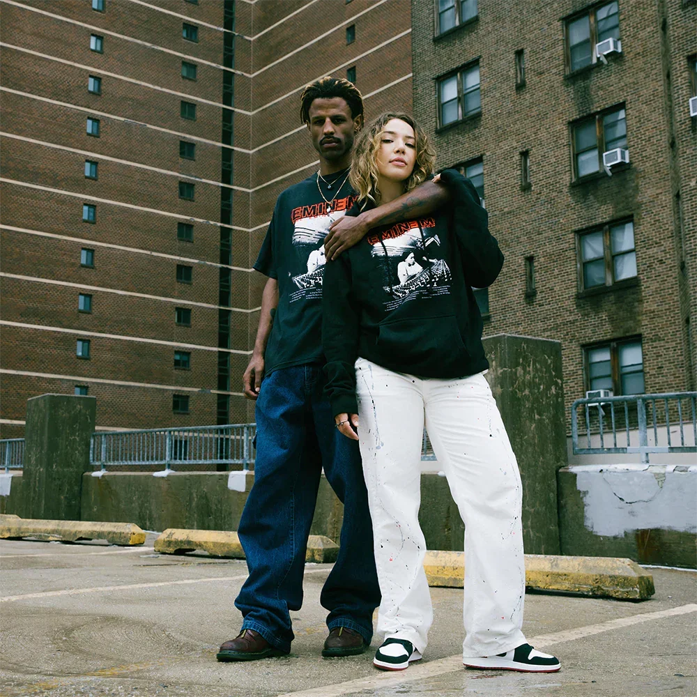 Two models in Eminem Show Studio hoodies on a city street