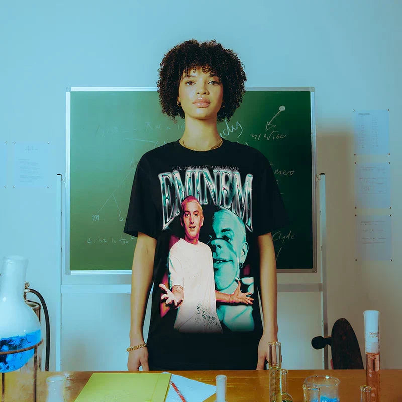 Woman wearing the black Eminem SSLP25 Chrome T-shirt with chrome logo and portraits