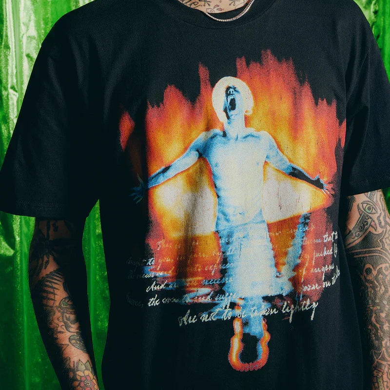 Close-up of the Eminem SSLP25 Fire T-shirt print with flames and figure artwork