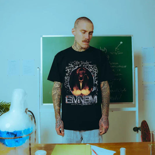 Man wearing the black Eminem SSLP25 Portrait T-shirt with flame portrait graphic