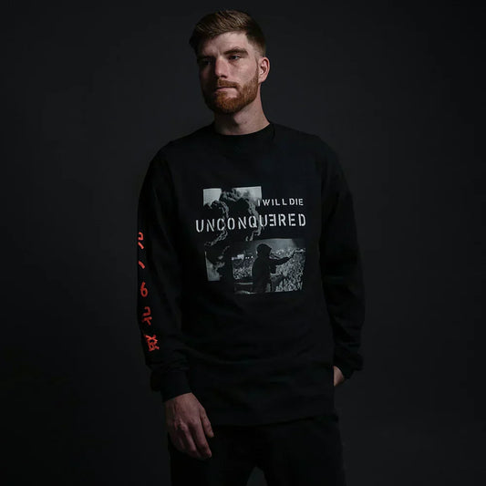 Man wearing the black Eminem Unconquered long sleeve tee, I Will Die Unconquered chest print
