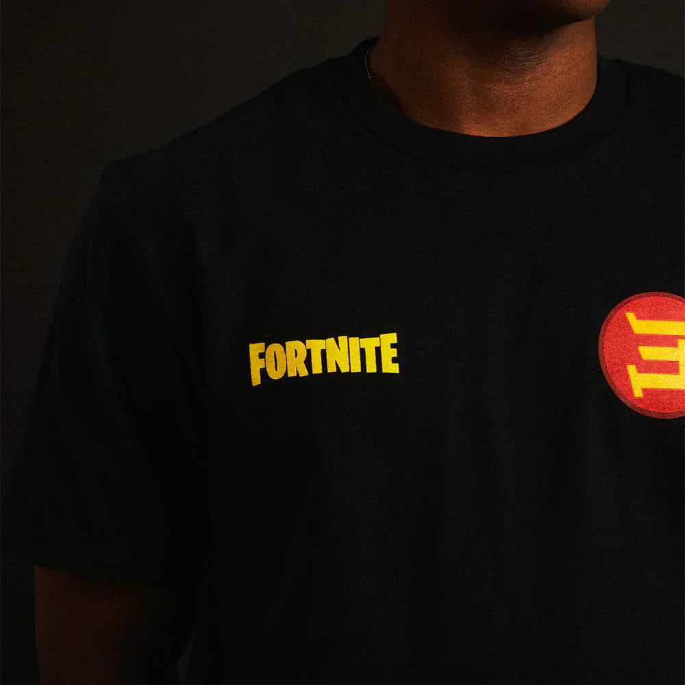 Chest print detail on the Eminem x Fortnite T-shirt, yellow Fortnite logo beside the red E