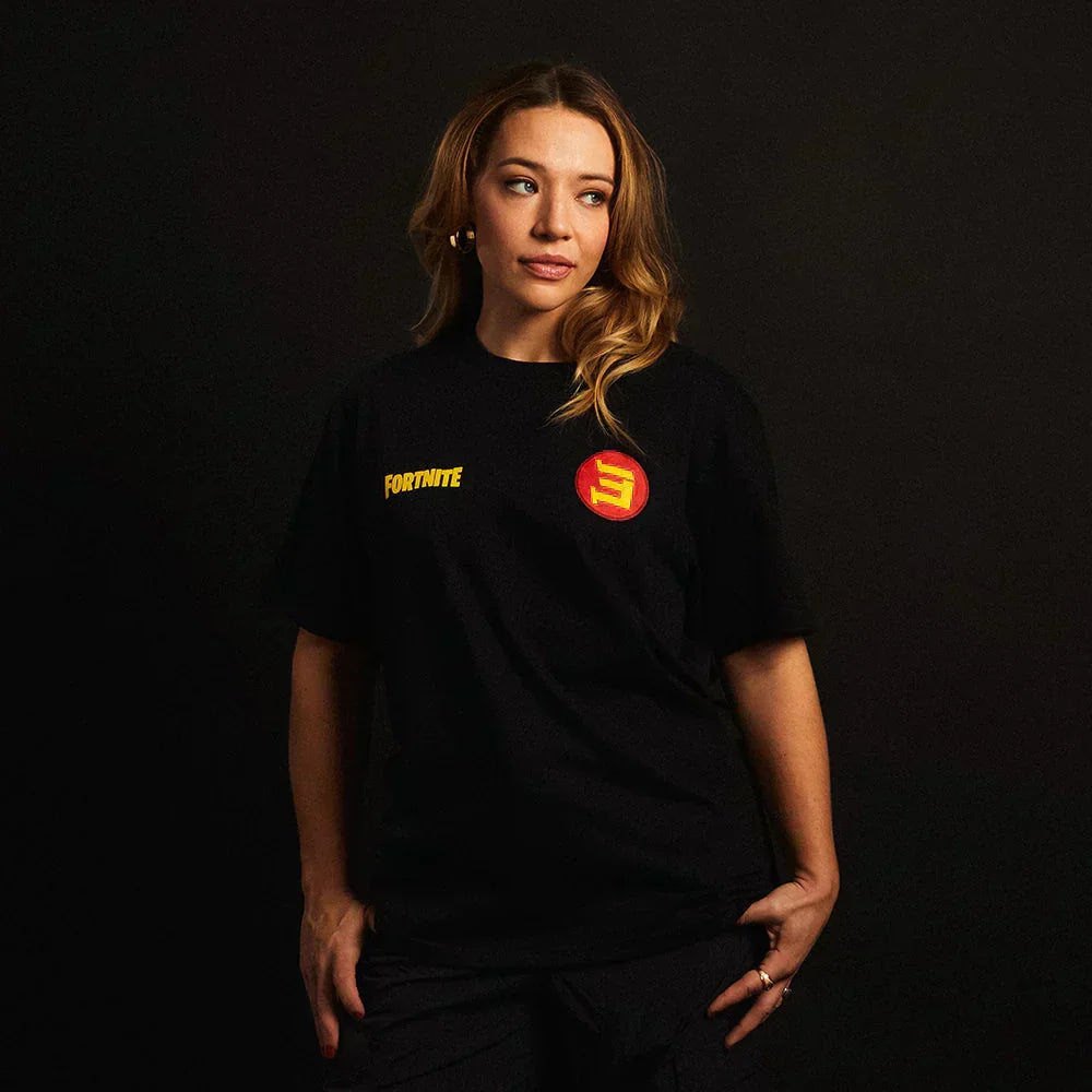 Woman wearing the black Eminem x Fortnite T-shirt with small yellow logo and red E print