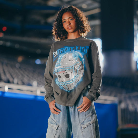 Woman in the Eminem x Detroit Lions All Grit long sleeve shirt with chrome helmet graphic