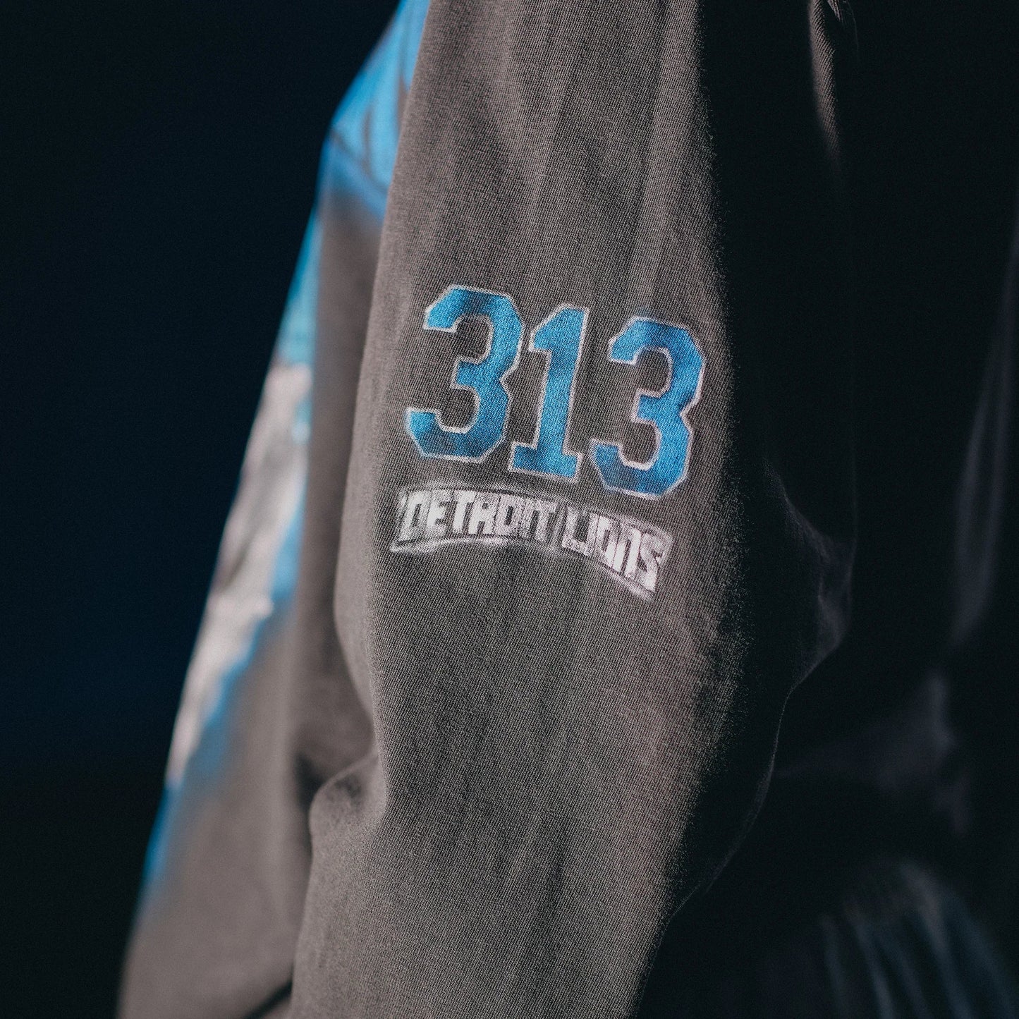 Sleeve print detail reading 313 Detroit Lions on the Eminem All Grit long sleeve shirt