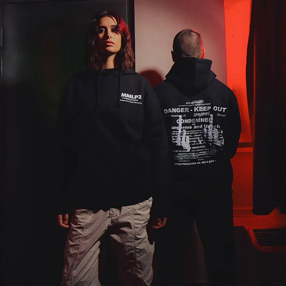 Two models in black Eminem MMLP2 Condemned hoodies with Danger Keep Out back print